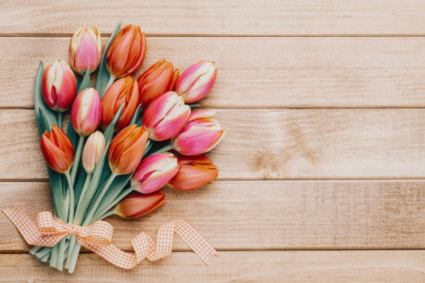 spring easter tulips in bucket on wooden vintage background. - ostern stok fotoğraflar ve resimler
