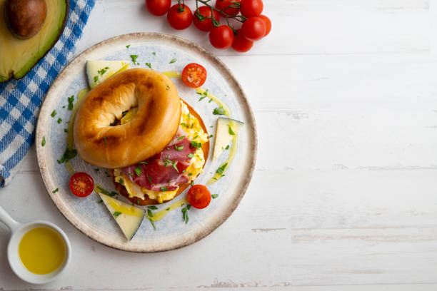 istock Toasted baggel with scrambled egg and Iberian ham and manchego cheese. 1431308873