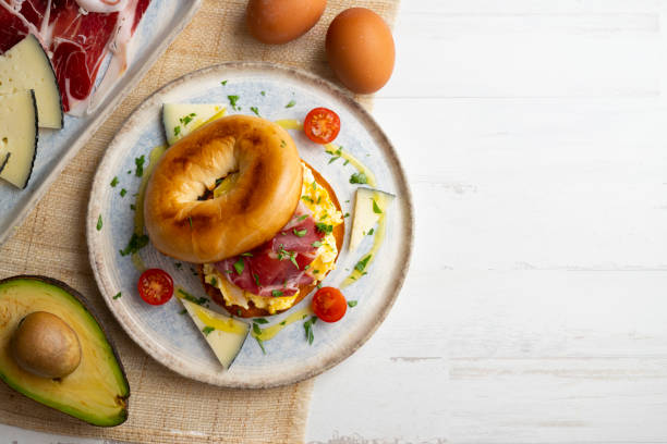 istock Toasted baggel with scrambled egg and Iberian ham and manchego cheese. 1431308923