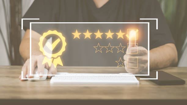 istock Customer Satisfaction Survey Concept, A man's hand using a smartphone gives a 5 star rating to show the highest level of satisfaction with excellent service.. 1431309626