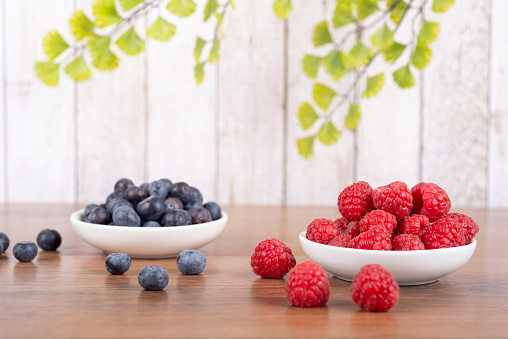 sweet colorful macaroons - small bisquit snacks - with blueberries and raspberries