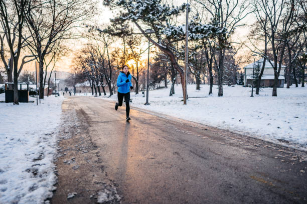 istock Young Woman Running In A Snowy Park 1431316743