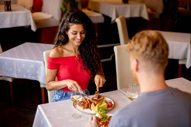 istock Young couple having lunch with white wine in the restaurant 1431319197