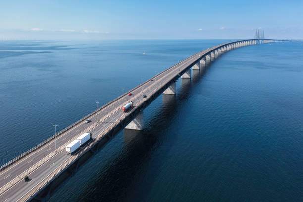 Transportation on the Öresund bridge across the sea Semi-truck with trailer and a fuel truck on the Öresund bridge between Malmö in Sweden and Copenhagen in Denmark. sea bridge stock pictures, royalty-free photos & images