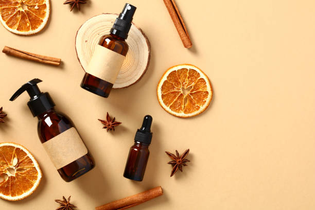 istock Fruit cosmetics with dry orange slices, cinnamon sticks, anise stars on beige table. Flat lay, top view. 1431323482