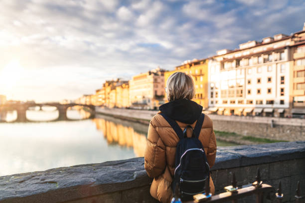 istock Tourist watching Arno river at sunset 1431323854