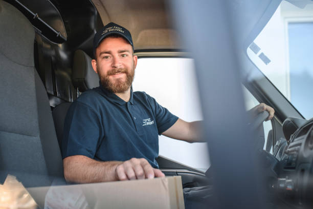 istock Young Delivery Man Sitting In Van Cockpit 1431325331