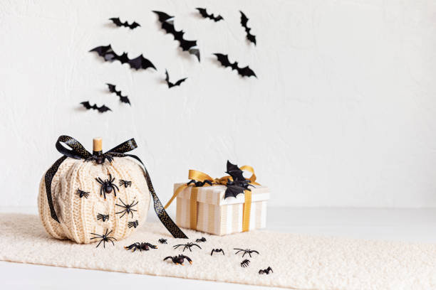 istock Modern interior decoration for halloween celebration with handmade knit pumpkin, spiders, bats and gift box 1431326660
