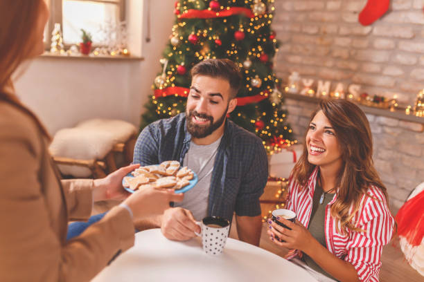 istock Couple spending Christmas day with friends at home 1431328421