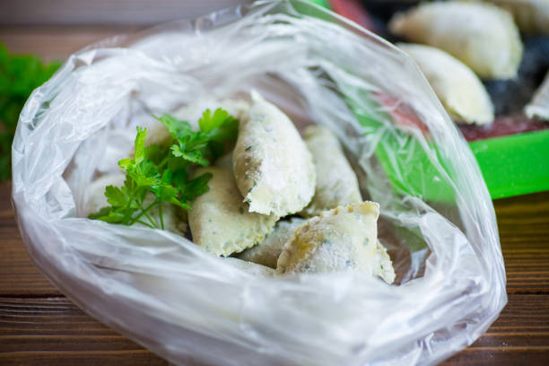 istock Raw green dough dumplings with parsley, dill. 1431330141