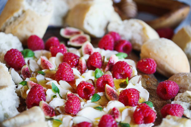 istock Dessert butter board topped with fresh raspberries, figs, sliced almonds, basil leaves 1431331117