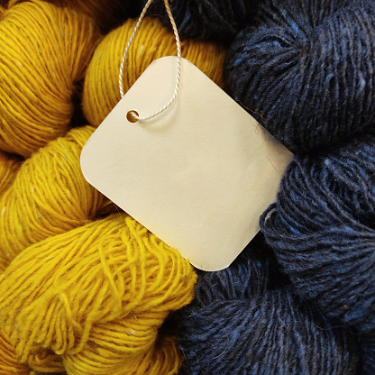 blue navy and yellow wool balls full frame with logo blanc paper tag