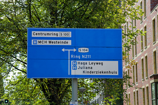 Dutch direction sign in blue and white  heading to the two big Hospitals in The Hague Westeinde en Haga Leyweg and also to Juliana childrens Hospital