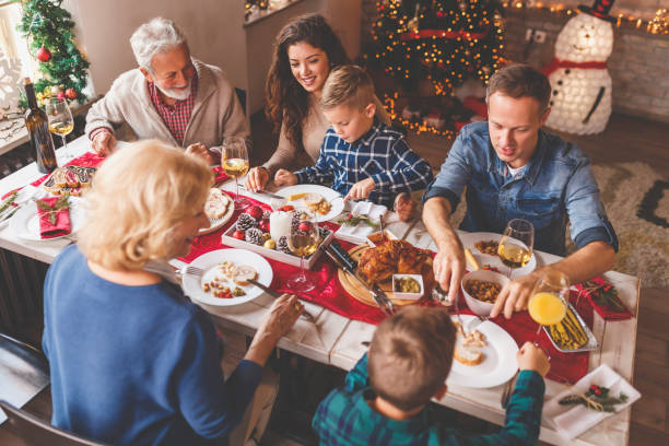 Family having Christmas dinner at home stock photo