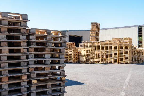 istock Wooden pallets stacked outdoors of a warehouse. 1431336265