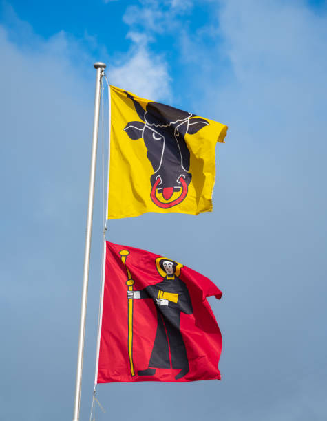 Cantonal flags at the border of cantons Uri (yellow flag) and Glarus (red flag) at Klausenpass in Switzerland