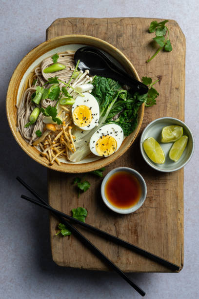 istock Top down view of Japanese ramen soup with boiled egg on wooden board, copyspace 1431341071