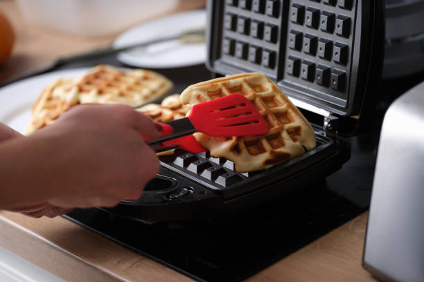 istock Belgian waffles in waffle iron in kitchen 1431346631