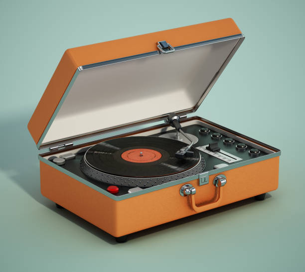 Portable analogue record player or turntable on green background stock photo