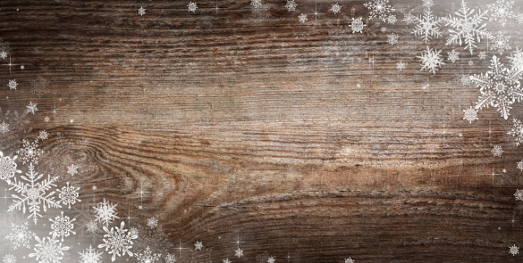 Panorama of vintage Christmas background with snowflakes and stars. Christmas and New Year holiday wooden background with snow and snowflakes decoration.