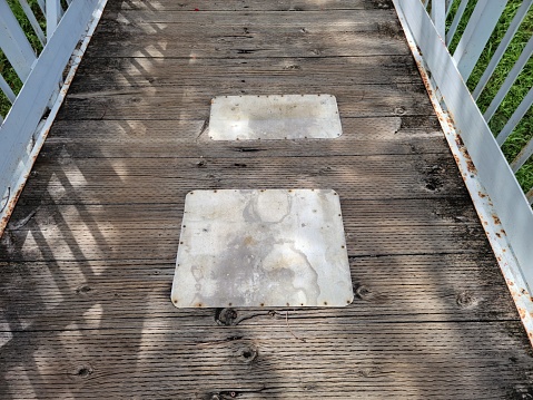 wooden walkway or bridge with metal to repair or mend it