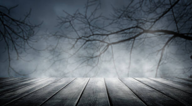 Spooky misty horror halloween background with empty wooden planks, ideal for product placement stock photo