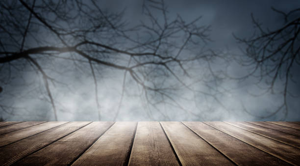 istock Spooky misty horror Halloween background with empty wooden planks, ideal for product placement 1431347636