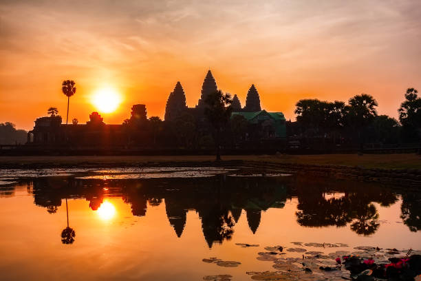 istock Ancient Angkor Wat temple in Siem Reap, Cambodia silhouette at sunrise with reflection. 1431347671