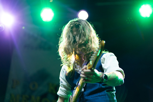 Caucasian ethnicity Young adult man playing electric guitar on music stage