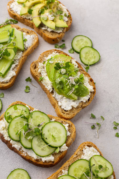 istock Vegetarian green sandwiches with avocado and cucumber with microgreens on a light background 1431348010