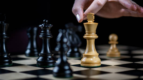 istock Wooden chess pieces on chess board 1431348071
