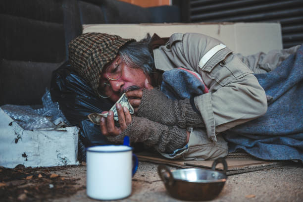 istock Someone is giving e few dollars to homeless man 1431351213