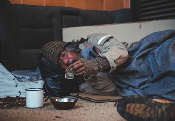 istock Someone is giving e few dollars to homeless man 1431351263