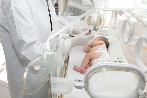 A newborn baby lies in boxes in the hospital. A child in an incubator. Neonatal and Premature Intensive Care Unit