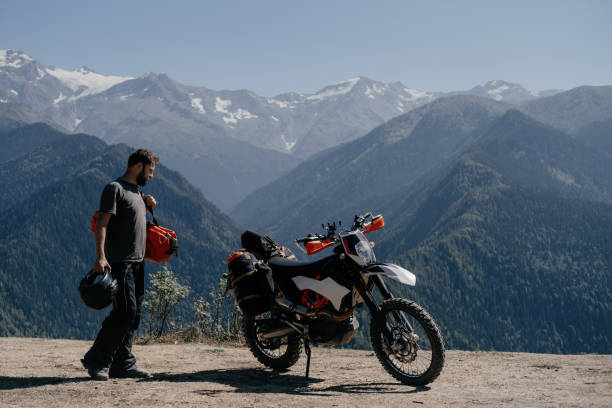 istock man enjoying a mountain view in motorcycle trip holding dry bag on his shoulder going during long journey on enduro motorcycle 1431356400