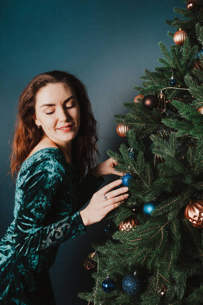 istock Seductive playful female portrait against Christmas tree 1431357438