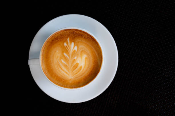 istock Latte art coffee in white cup on dark background 1431362892
