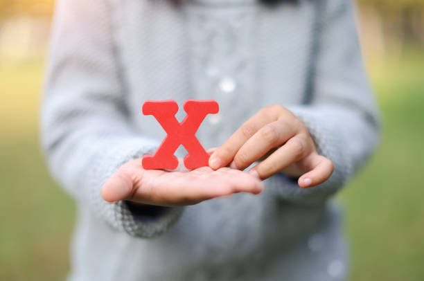 Child Holding Letter "X" stock photo