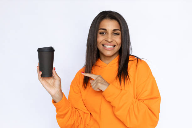 istock Young Hispanic woman pointing at paper cup 1431366244