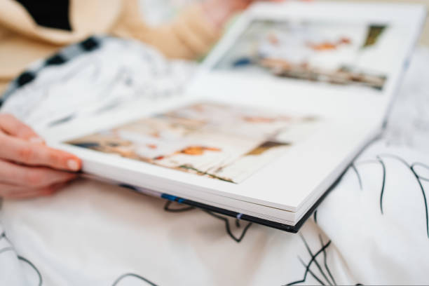 istock Selective focus and blurry photos. a woman holds a photo book. 1431368799