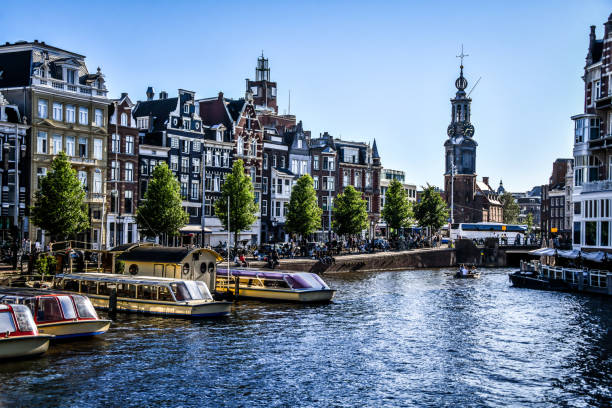 istock Munttoren Behind Busy Canal In Amsterdam, The Netherlands 1431369730