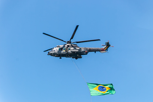 helicopter with the flag of Brazil in Copacabana in Rio de Janeiro, Brazil - September 07, 2022: Celebration of Brazil's Independence Day at Copacabana Beach in Rio de Janeiro.