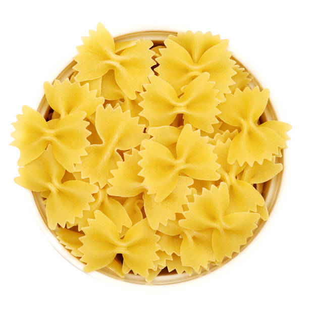 istock Italian pasta Farfalle in a white cup on a white background. View from above 1431379094