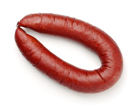 Top view of smoked beef sausage isolated on white