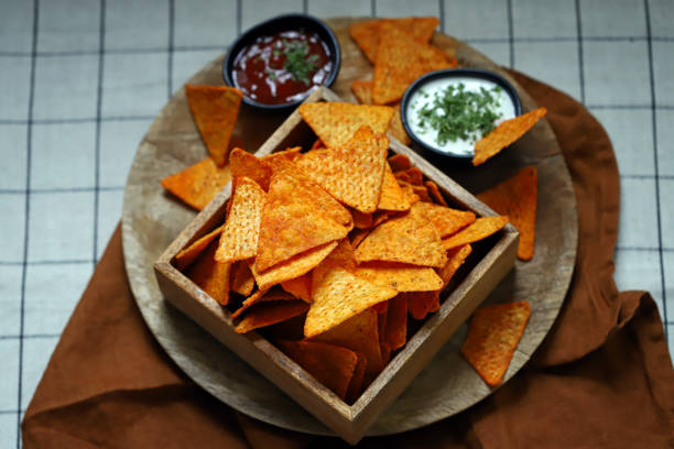 istock Selective focus. Corn chips nachos in a wooden bowl with sauces. 1431383662