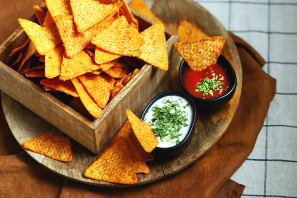 istock Selective focus. Corn chips nachos in a wooden bowl with sauces. 1431383666