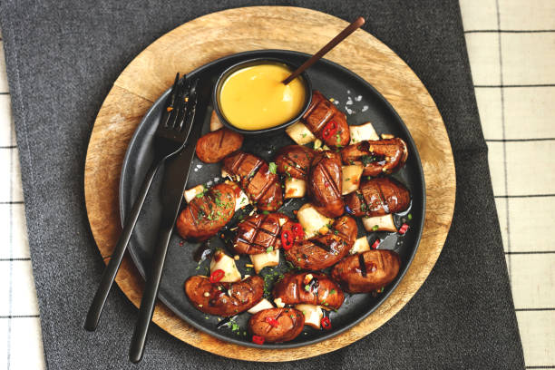 istock Appetizing juicy grilled mushrooms on a dark plate with spices. Macro. 1431383732