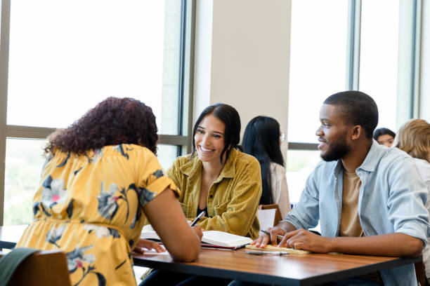 istock Three diverse college friends meet at library to study 1431383862