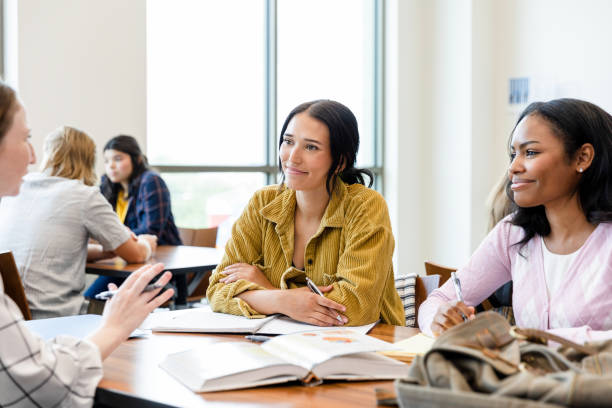 istock Two female university students smile while listening to friend's ideas 1431383871