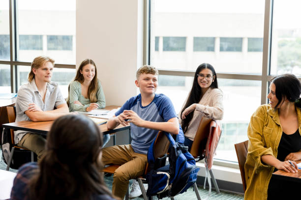 istock Teen boy smiles and comments during lecture 1431383887